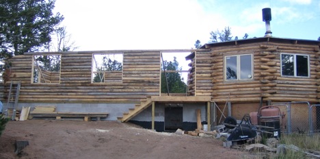 View of the log home with the walls to the top of the windows