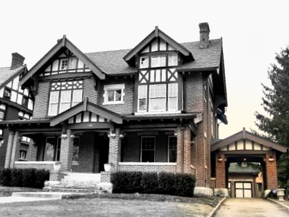 A drive-through covered carriage porch leads to a detached garage.