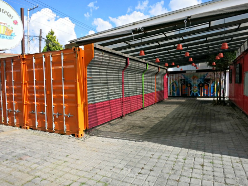 Metal roller doors and a courtyard covering  make for small stalls for vendors.