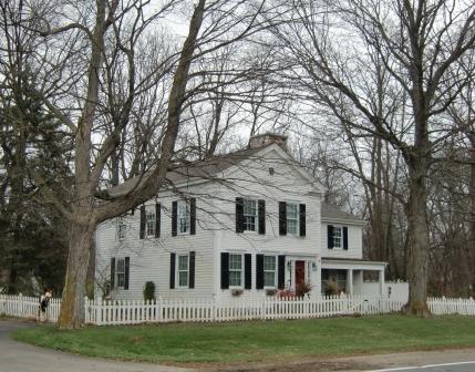 Greek Revival home in Ann Arbor, MI - The off center door on a narrow house allowed you to have a hallway on the side and allow for a wide room. 