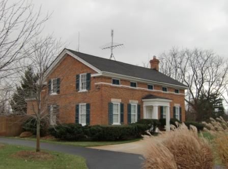 Take out the entablature with the little windows and it would be a lovely, but ordinary home.  The Greek touches make this standout.  I won't say it adds to its beauty, but it adds to its interest.