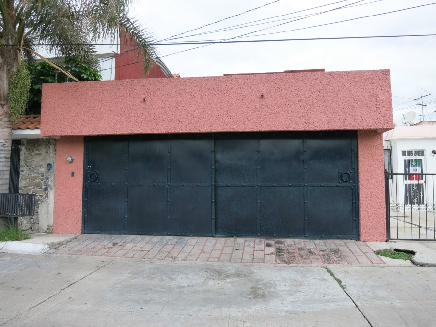 This is really a double-wide garage, but the massive, riveted metal doors are a common style for garages and gates alike.