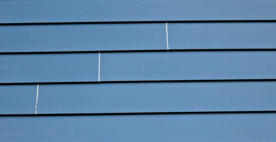 My siding shrinks in the cold, revealing a little unpainted area on the end of the covered siding
