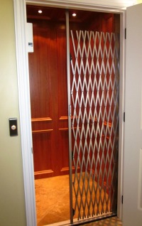 Most residential elevators will have a protective grate or door that travels with the cab.
