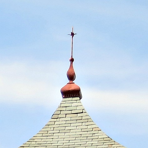 A roof finial on a hipped turret roof.