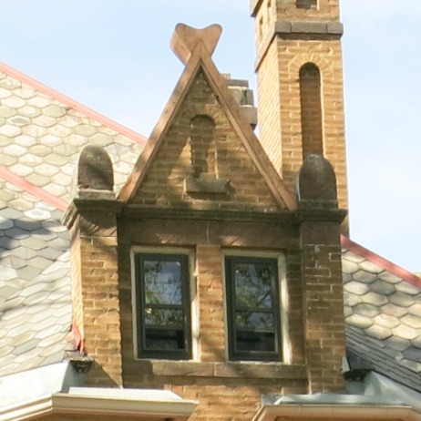 This dormer has three finials. The ones on the side are for visual effect, balancing out the top finial.
