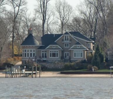 A grand home on the lake at Holland, MI has a hint of the Victorian in its layoug