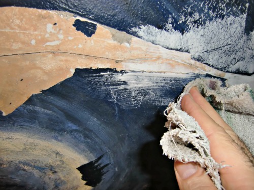 Wiping off excess caulk and spackling is part of the plaster ceiling repair