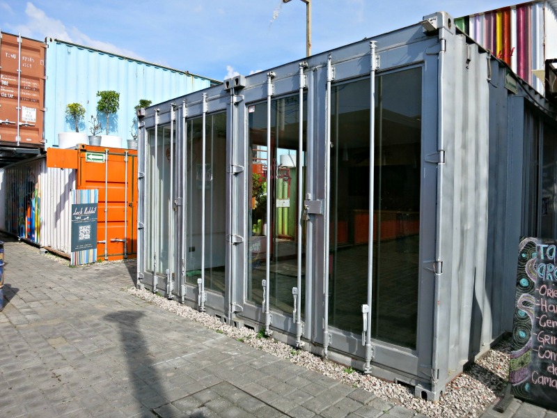 All containers have doors on one end. Here two containers side-by-side have French Doors with an industrial look.