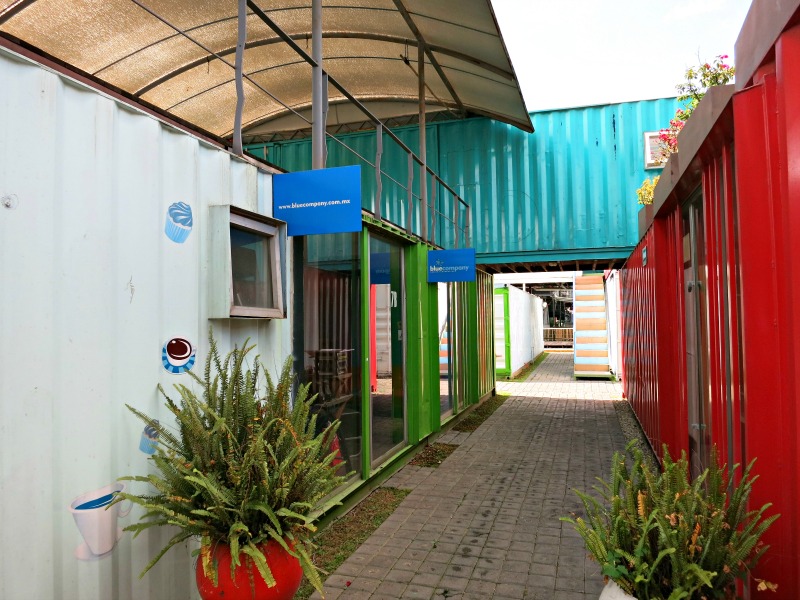 The building block nature of containers can create interesting spaces. Here a container straddles a corridor, forming a covered entryway.