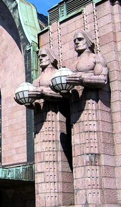 Art Nouveau Helsinki Central Railway Station by Eliel Saarinen has giant guards in the form of lamp holders