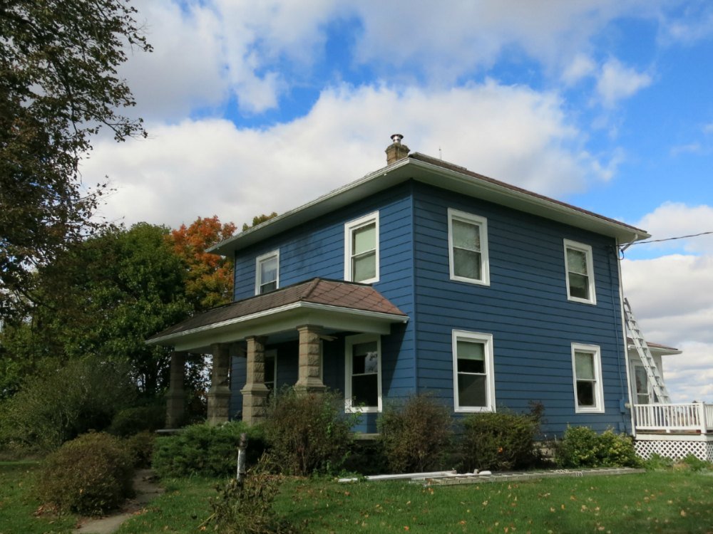 My house with the aluminum siding painted blue, but absent the trim