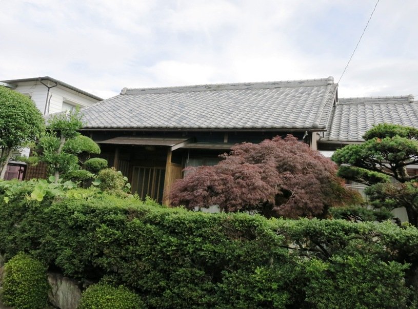 Well-formed hedges will do the trick where stone is not in the budget. Japan houses are usually coupled with private gardens.