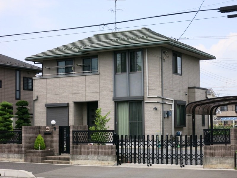 This Japan House is mostly modern, but softened with a hipped roof that evokes traditional Japanese architecture.