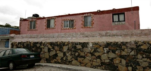 A Mexican house hidden behind a wall. Maybe it is beautiful. Maybe it isn't.