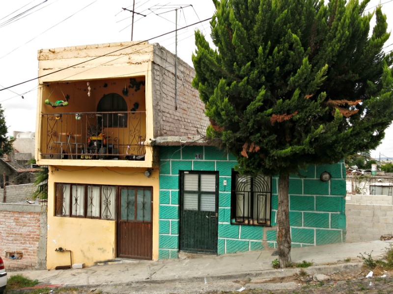 Small need not mean boring, Green blocks with a strong diagonal pattern yields a lively home in hillside home in the Mexican city of Queretaro.