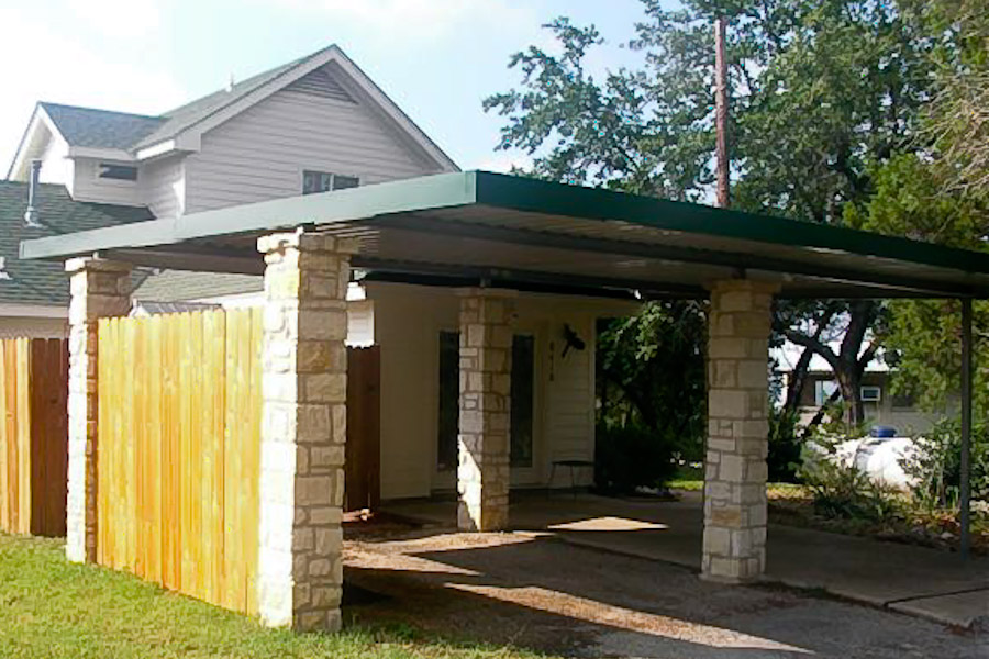 Car port with flat roof and stone columns