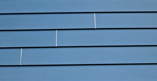 My siding shrinks in the cold, revealing a little unpainted area on the end of the covered siding