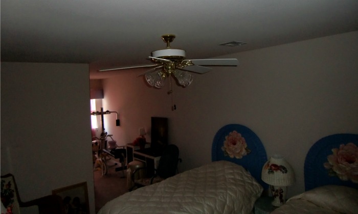 This is an orphan room inside an attic space. Only one window lets light in and it is constricted by a hallway. Another dormer or a skylight would go a long way towards making this a cheerful room.