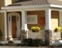 A vibrant mustard yellow front porch