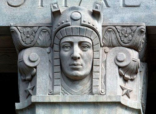 This is a war memoria, so this Art Deco bust probably has something to with Mars or the warrior spirit.  He certainly isn't a modern warrior.