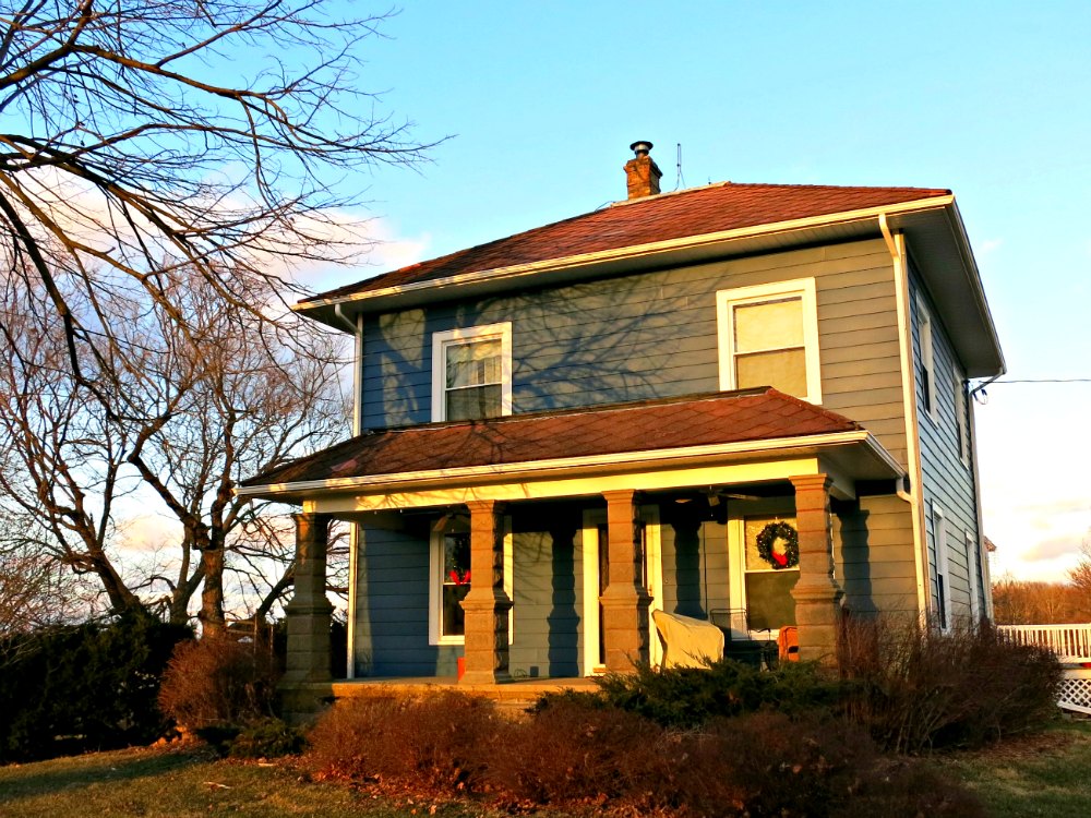 The house's exterior color lookks darker in the golden tones of evening.