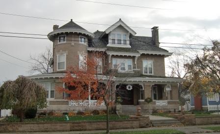 A wraparound porch surround this brick Victorian in Marysville, OH.  Part of the porch has been enclosed.