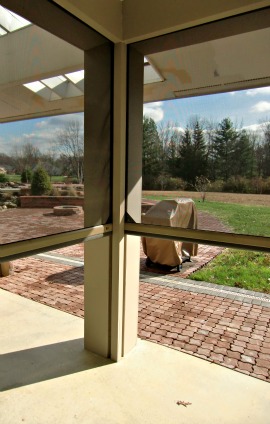 These retractable screens are halfway down.  When fully retracted the porch is completely open.  When closed the porch is protected from bugs by the screens.