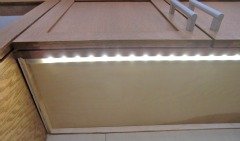 Under-counter LED lighting in an accessible kitchen.