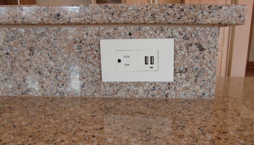 A siltstone counter and an accessible outlet.  The outlet includes USB chargers for their phones.