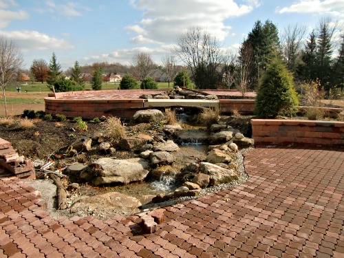 The patio view of the watercourse.  The patio extends to the top of the mound thanks to a gently-sloped wheelchair ramp and walkway.