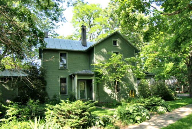 Green home is camouflaged in the woods